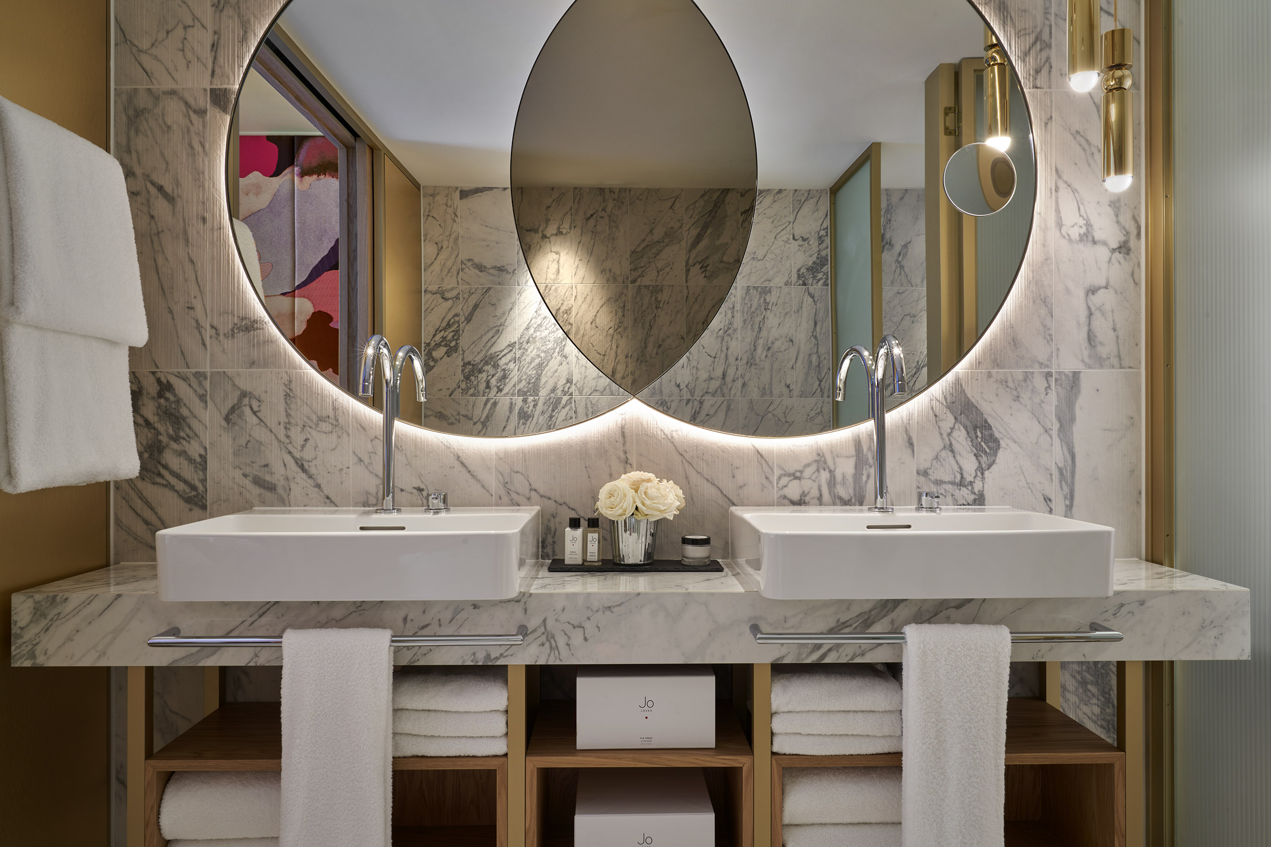Modern round mirrors in marble bathroom